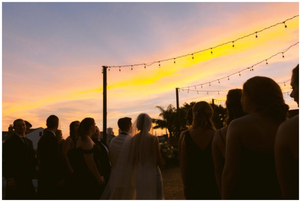 The sun sets at the end of the rooftop ceremony