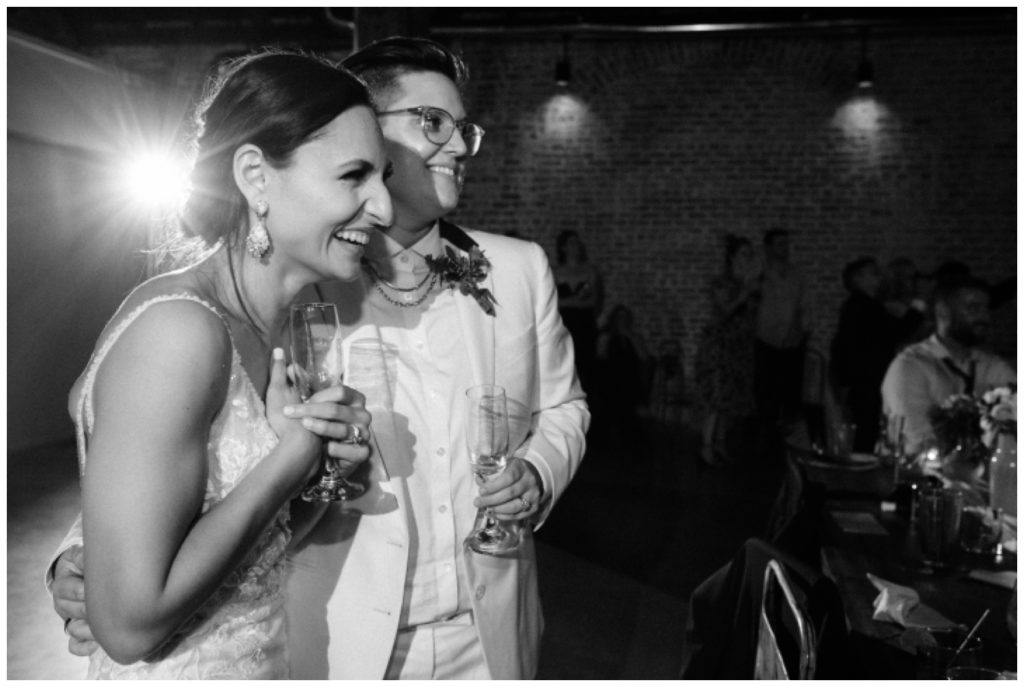 The couple laughs and listens to toasts