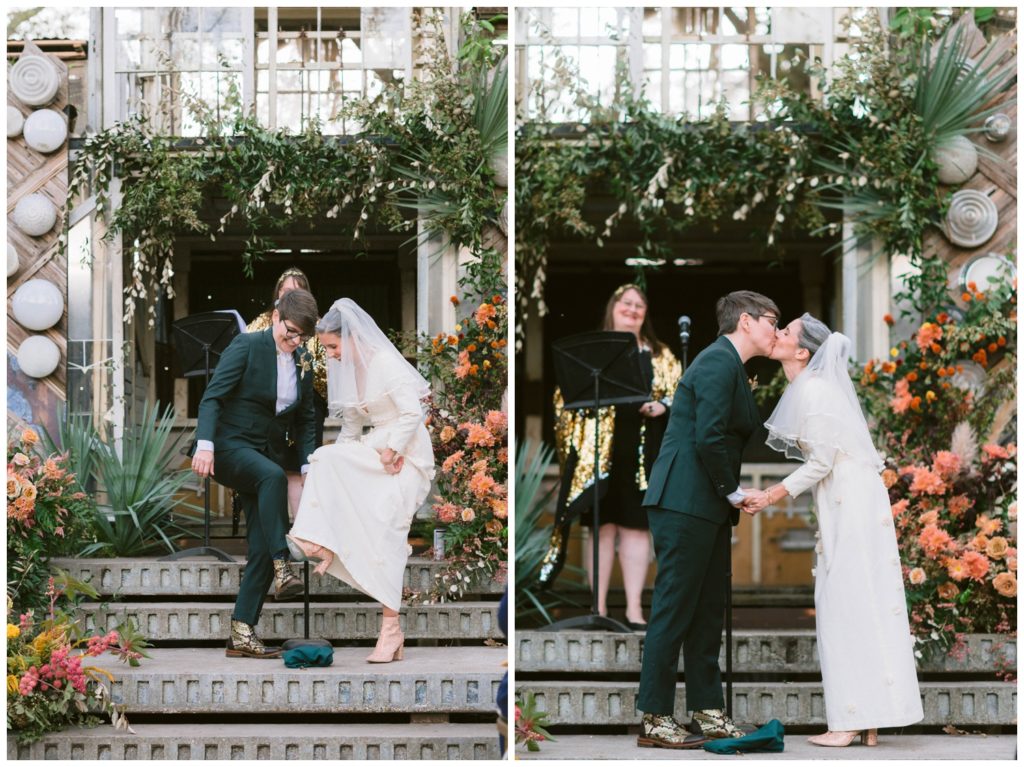 The couple smashes the glass and kisses at the end of the Music Box Village wedding