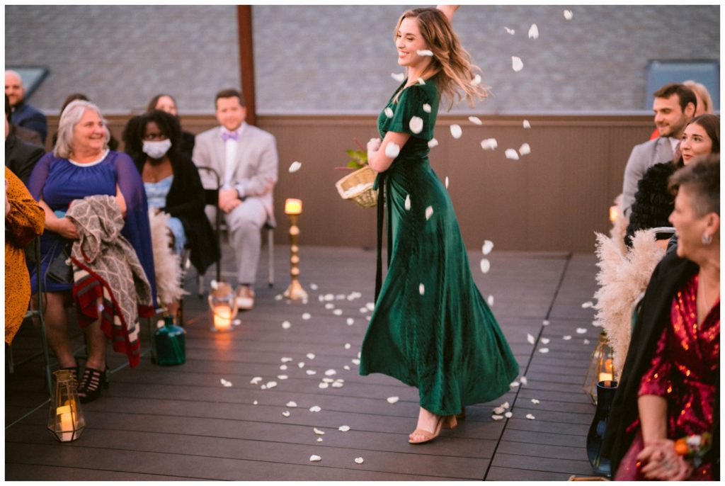 A flower person twirls at a two bride wedding ceremony