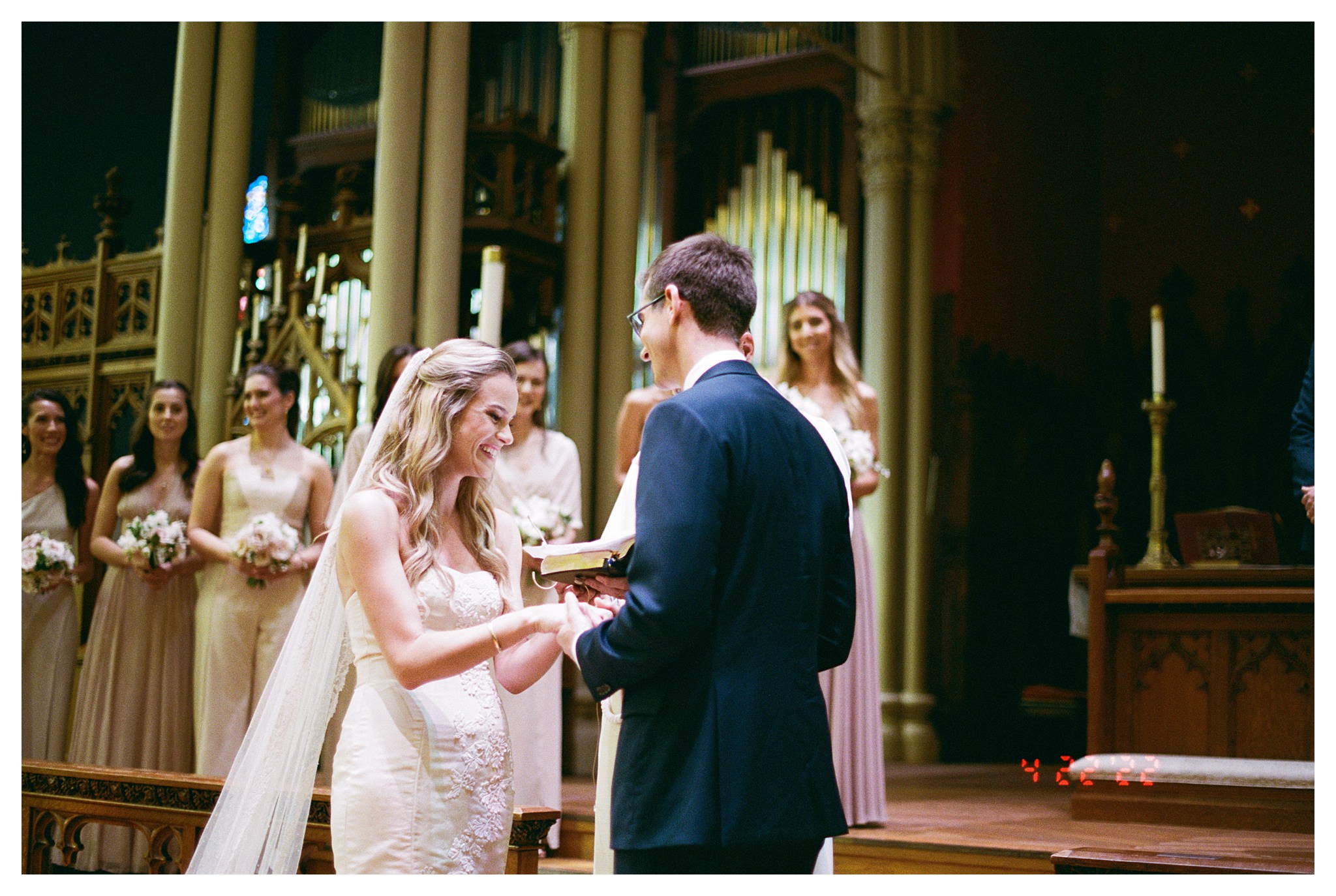 A man puts a ring on a woman’s finger during a church wedding.