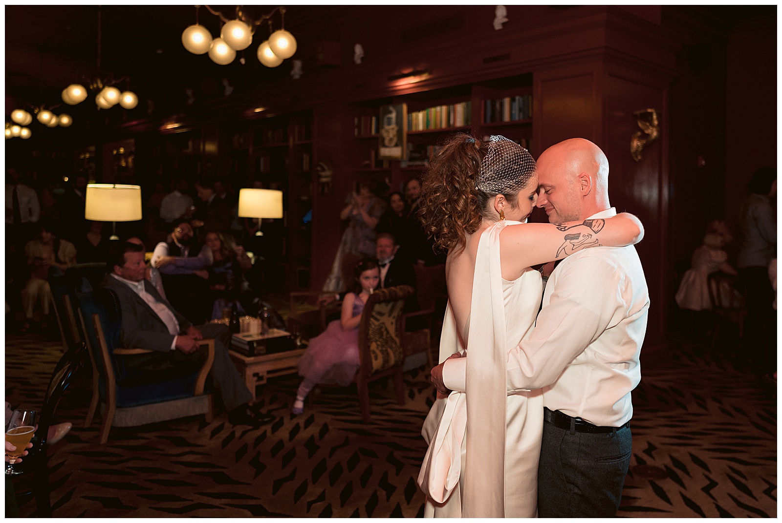 A couple embraces during their first dance.