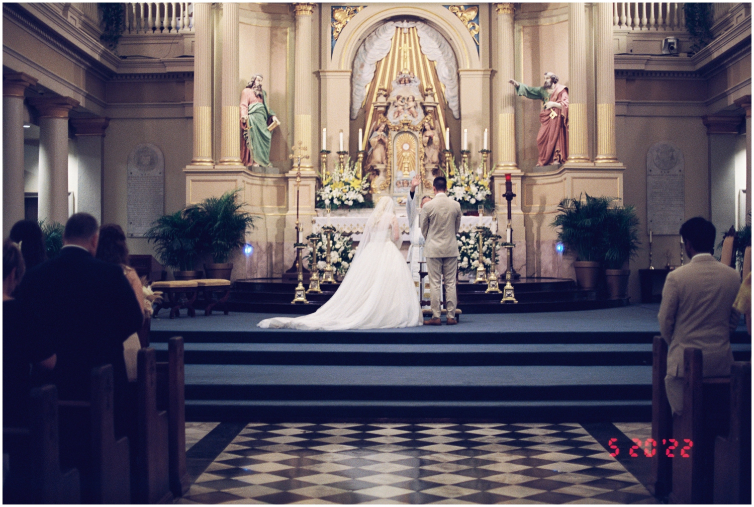 A couple stands at the altar for their intimate wedding at St. Louis Cathedral.