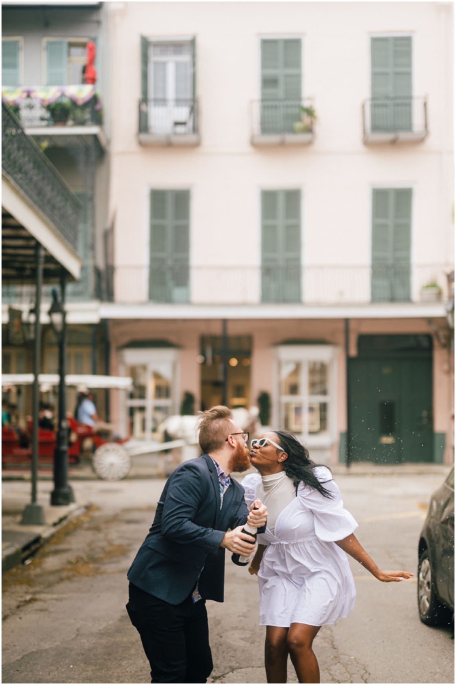 Dan and Paris kiss over the open champagne bottle in their spring engagement photo.