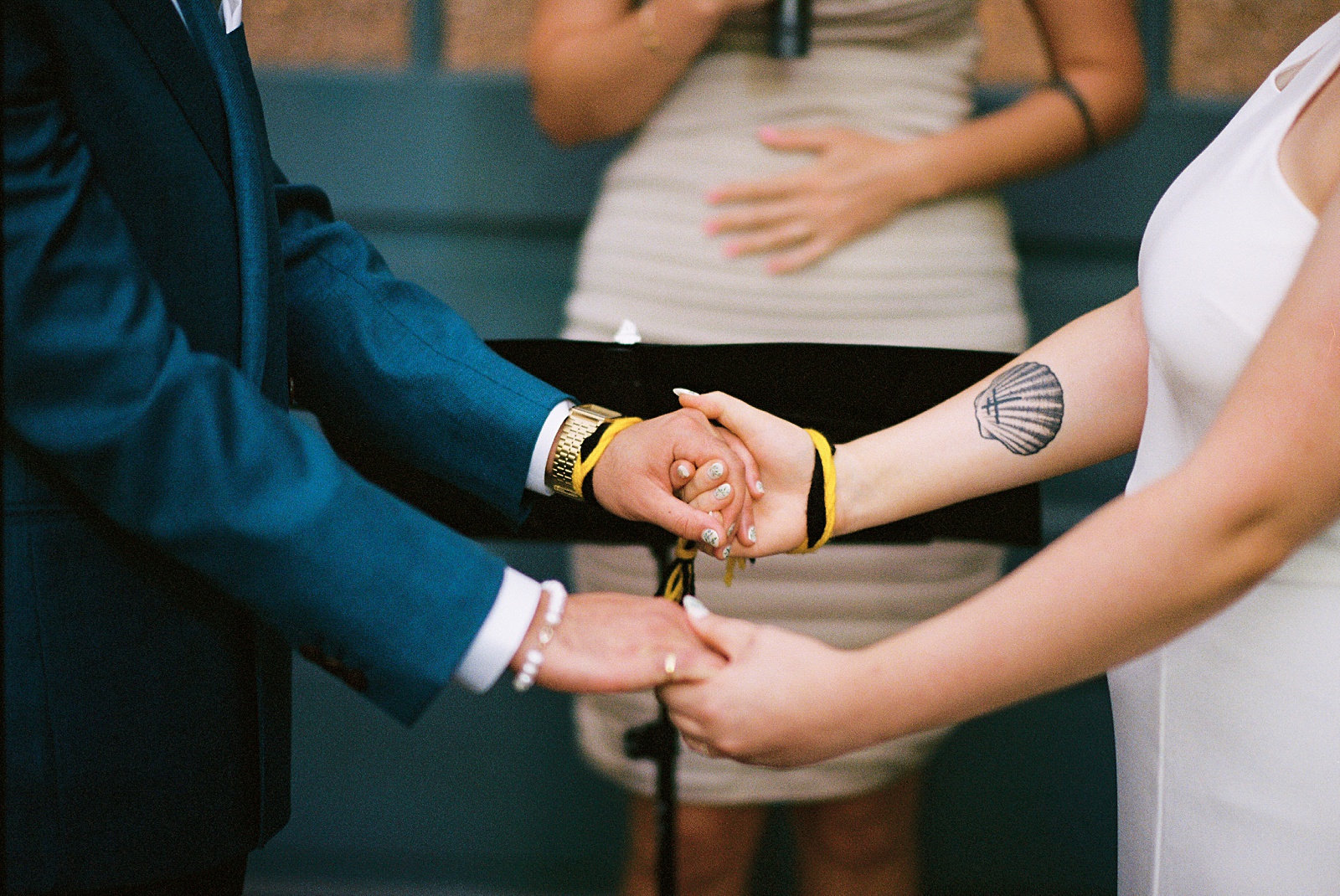A couple holds hands during a handfasting at a Philadelphia wedding.