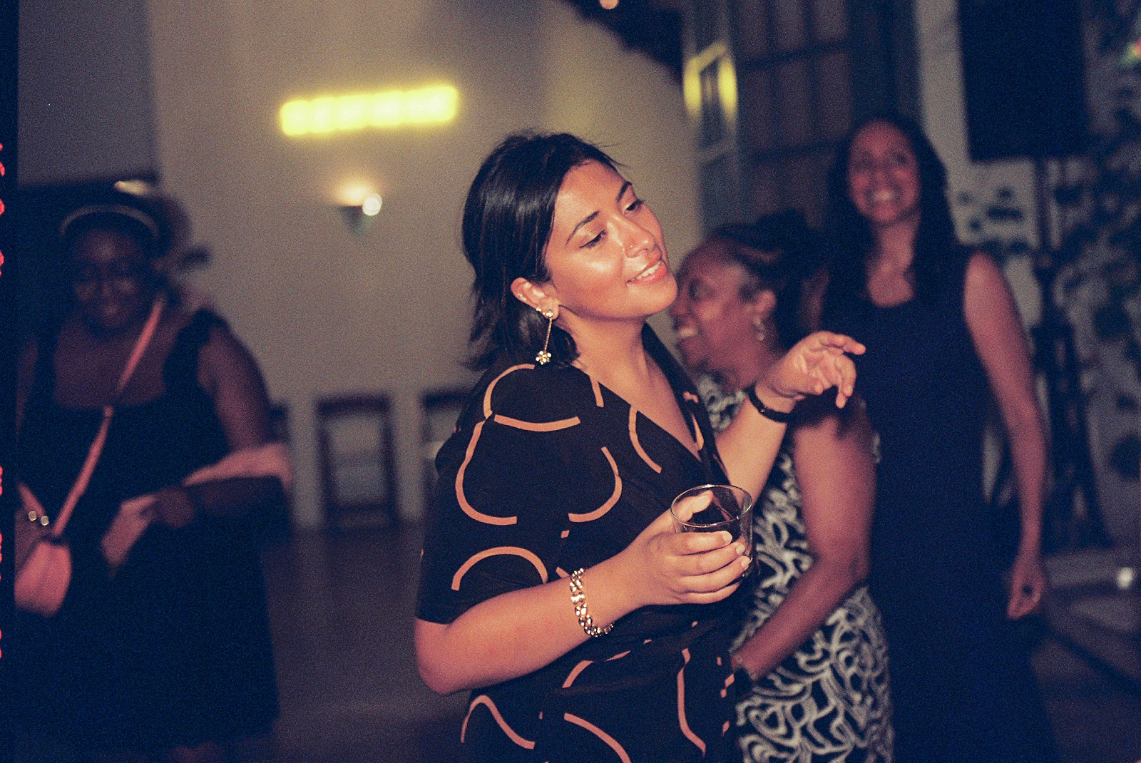 A wedding guest dances and smiles.