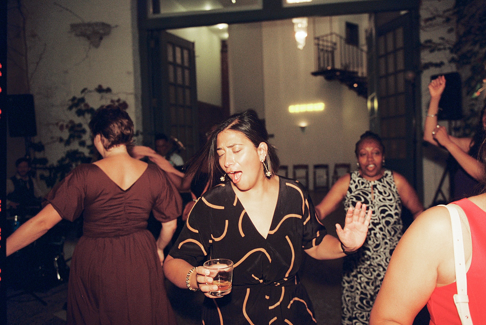 Wedding guests dance in a wedding photo on film.