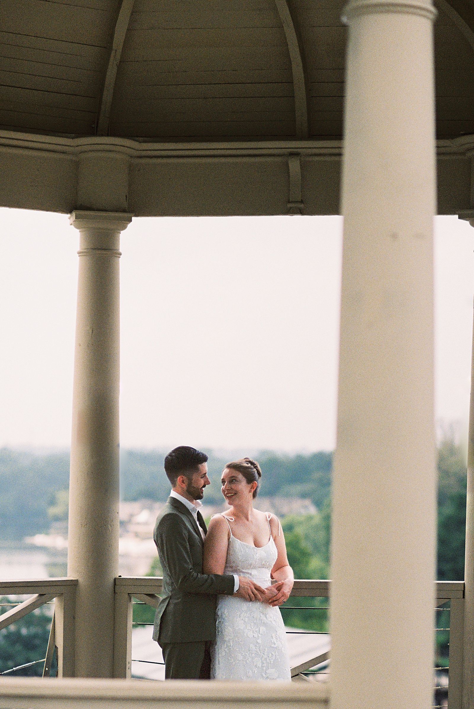 A bride and groom stand in a gazebo behind the art museum before their Philadelphia elopement.