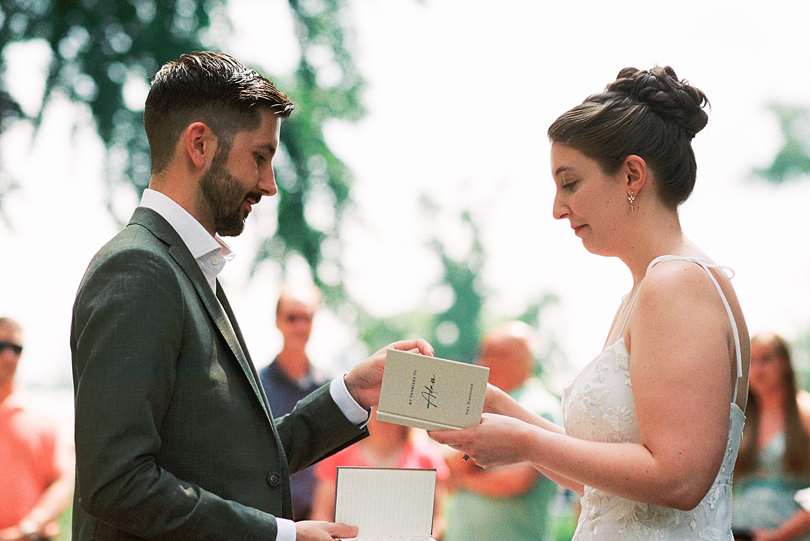 A bride and groom exchange rings at their summer Philadelphia elopement in Fairmount Park.