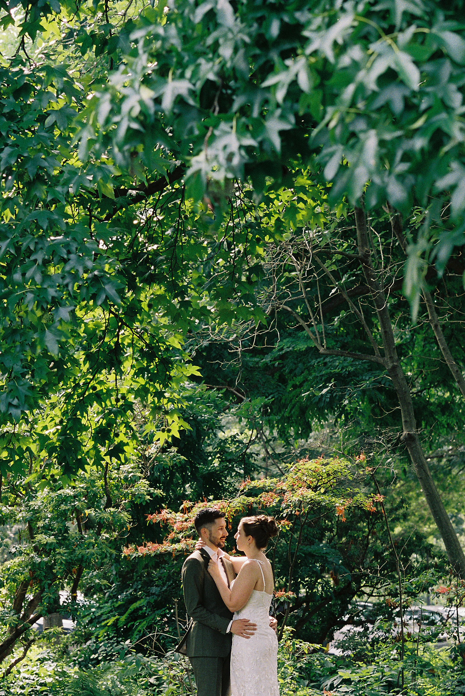 A Philadelphia bride and groom cuddle in a garden after their elopement at Fairmount Park.