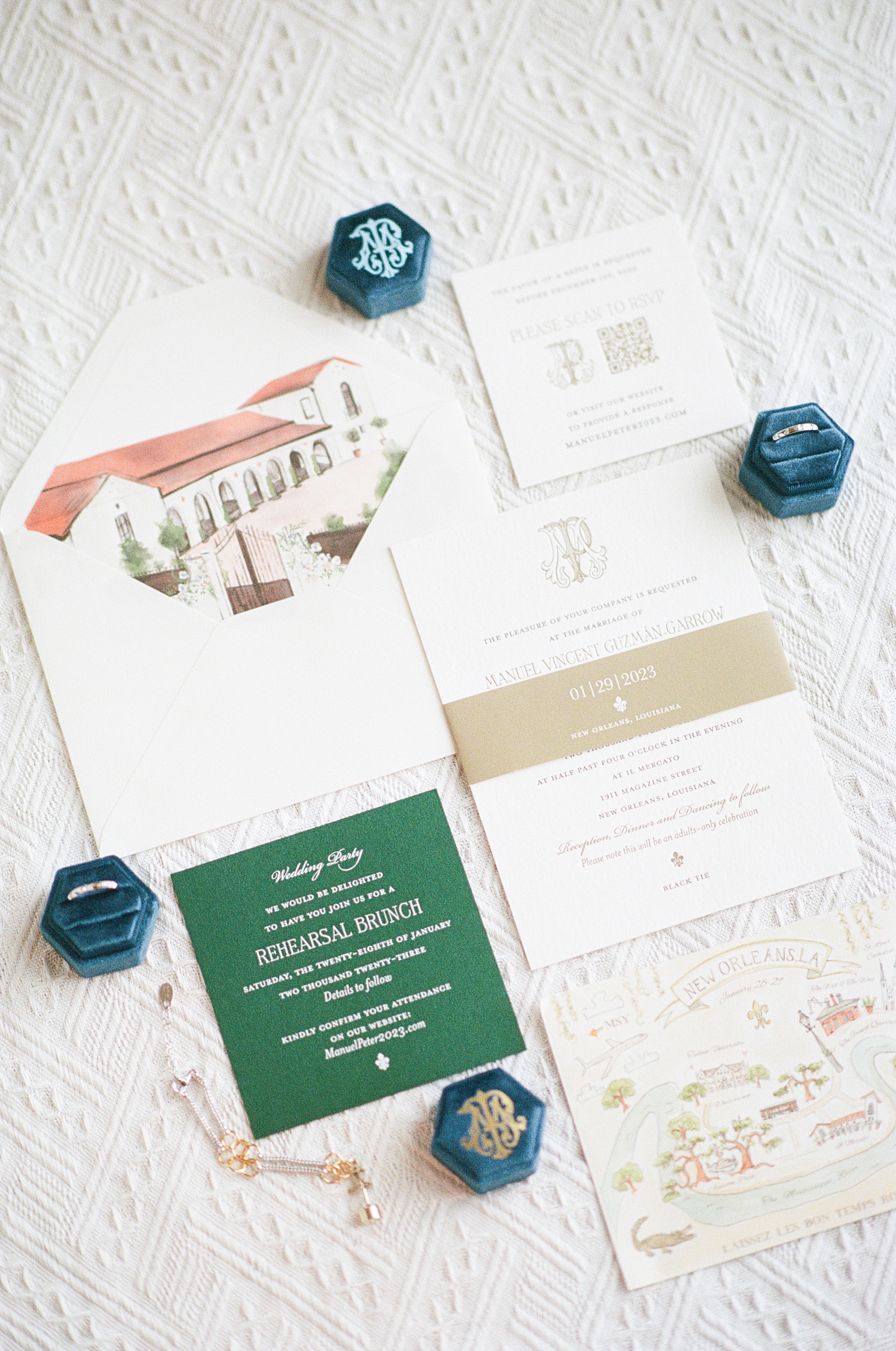 Custom wedding invitations sit on a lace backdrop.