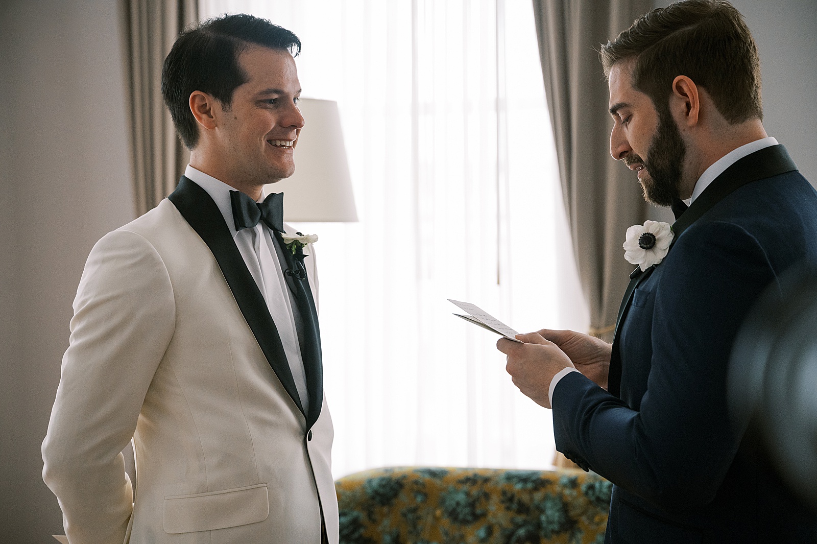 Two grooms exchange private vows in a hotel suite.