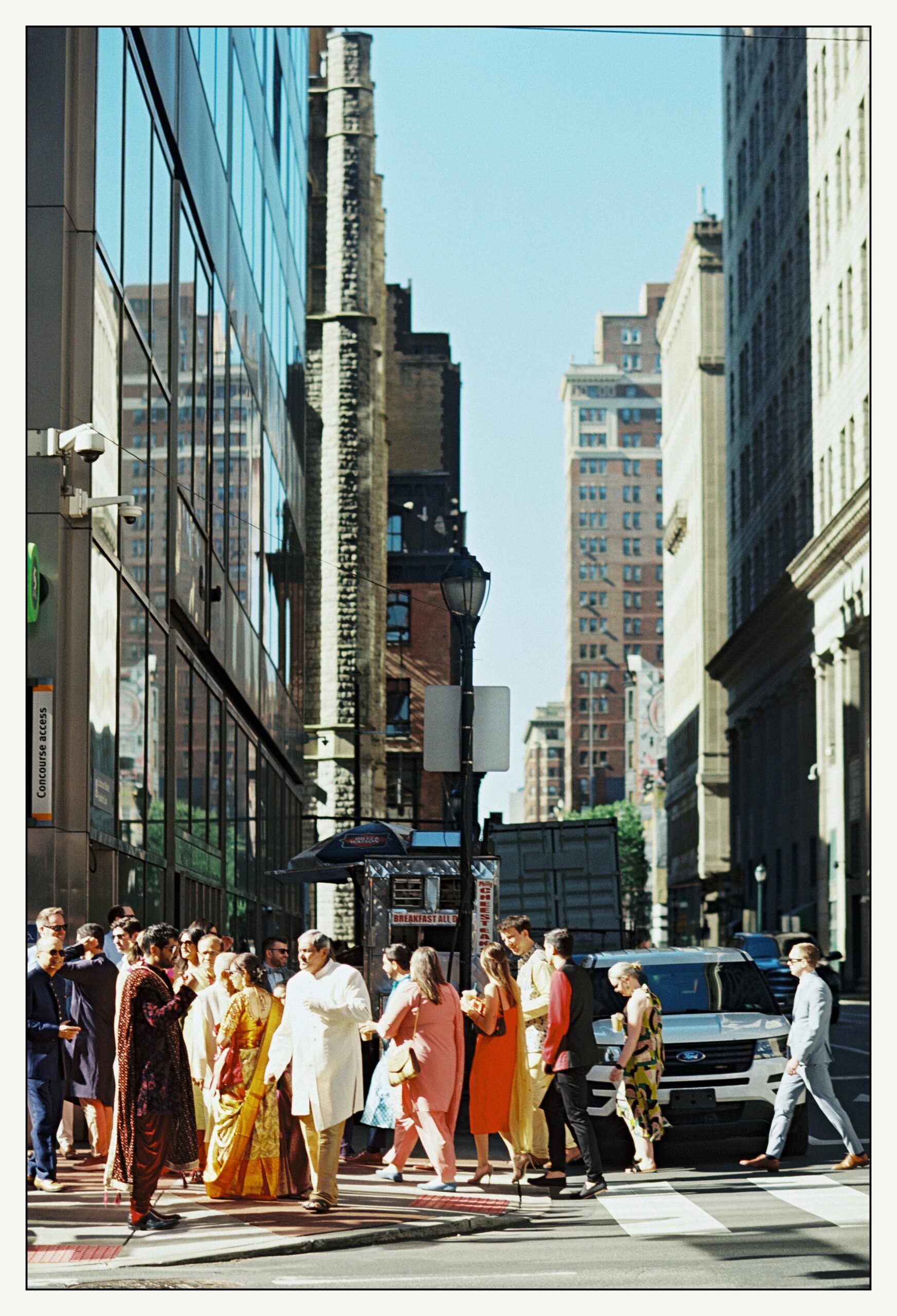 Wedding guests gather on a Center City sidewalk before an Indian wedding in Philadelphia.