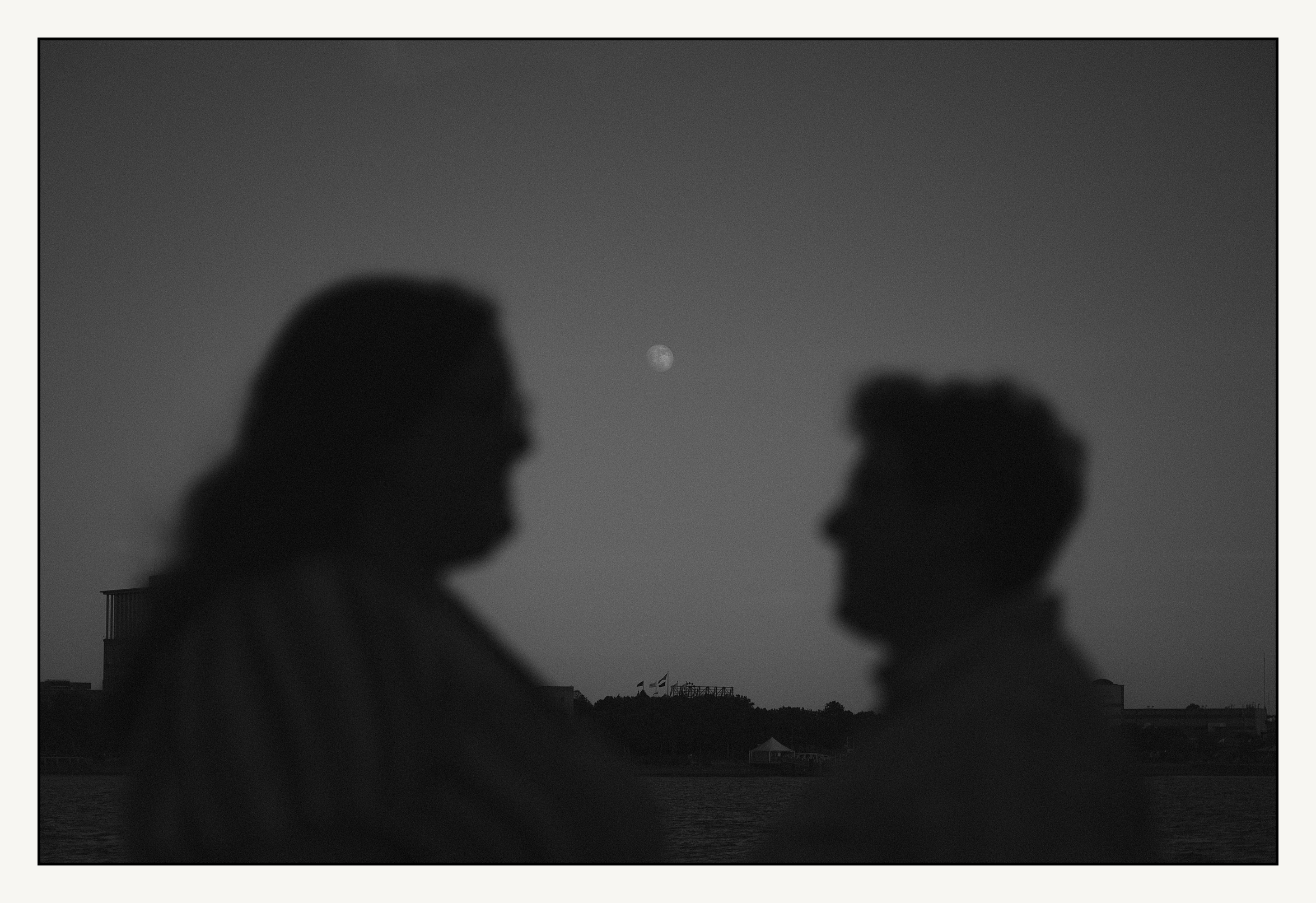 A moon shines over Penn's Landing in a film engagement photo.
